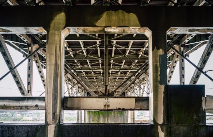 A high-fidelity architectural cross-section revealing a pristine, perfectly structured upper tier resting heavily upon a crumbling, chaotic foundation.